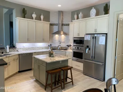a kitchen with granite countertop a sink appliances and cabinets