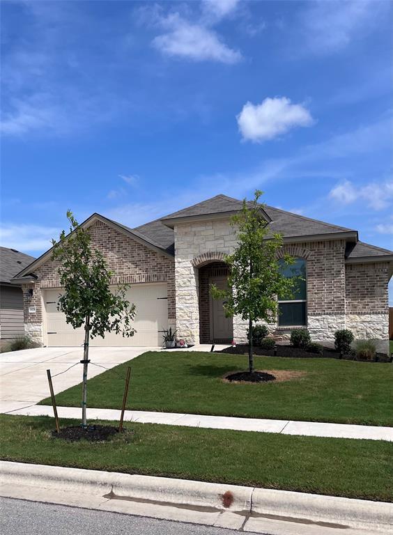 1828 T H Johnson Drive Taylor, TX 76574 - Photo 1 of 11 a view of a white house with a big yard and potted plants