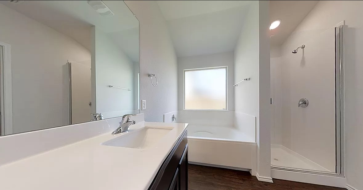 1828 T H Johnson Drive Taylor, TX 76574 - Photo 7 of 11 a bathroom with a bathtub and a sink