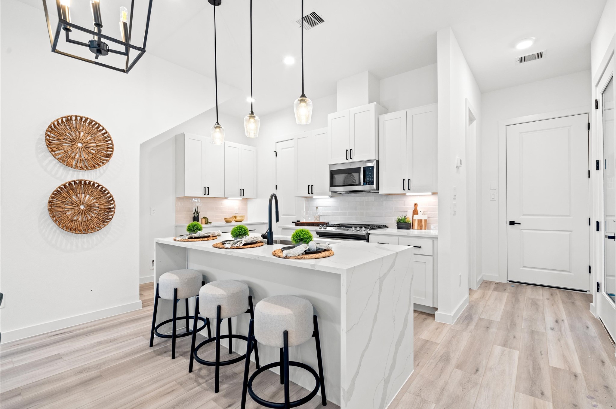 6421 Madrid Street Houston, TX 77021 - Photo 4 of 25 Quartz waterfall island, stainless steel appliances, and modern shaker cabinetry throughout the kitchen