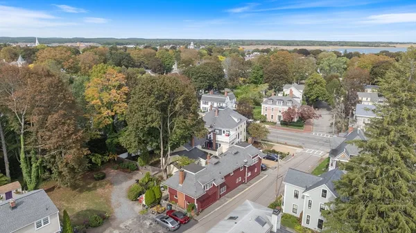 an aerial view of a house with a yard and lake view