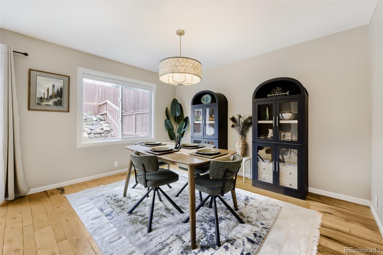 175 Xenon Street Denver, CO 80228 - Photo 11 of 37 a view of a dining room with furniture and chandelier