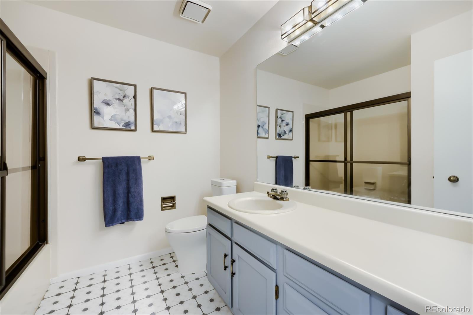 175 Xenon Street Denver, CO 80228 - Photo 19 of 37 a bathroom with a sink a toilet and shower