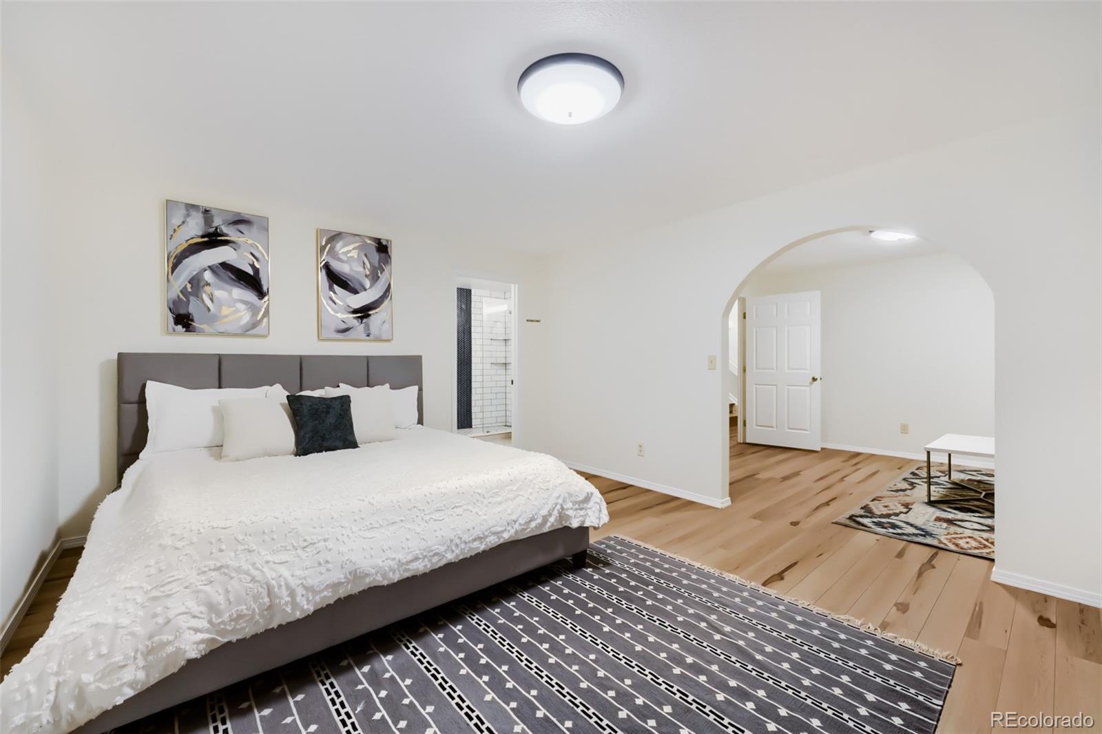 175 Xenon Street Denver, CO 80228 - Photo 24 of 37 a bedroom with a bed and a painting on the wall
