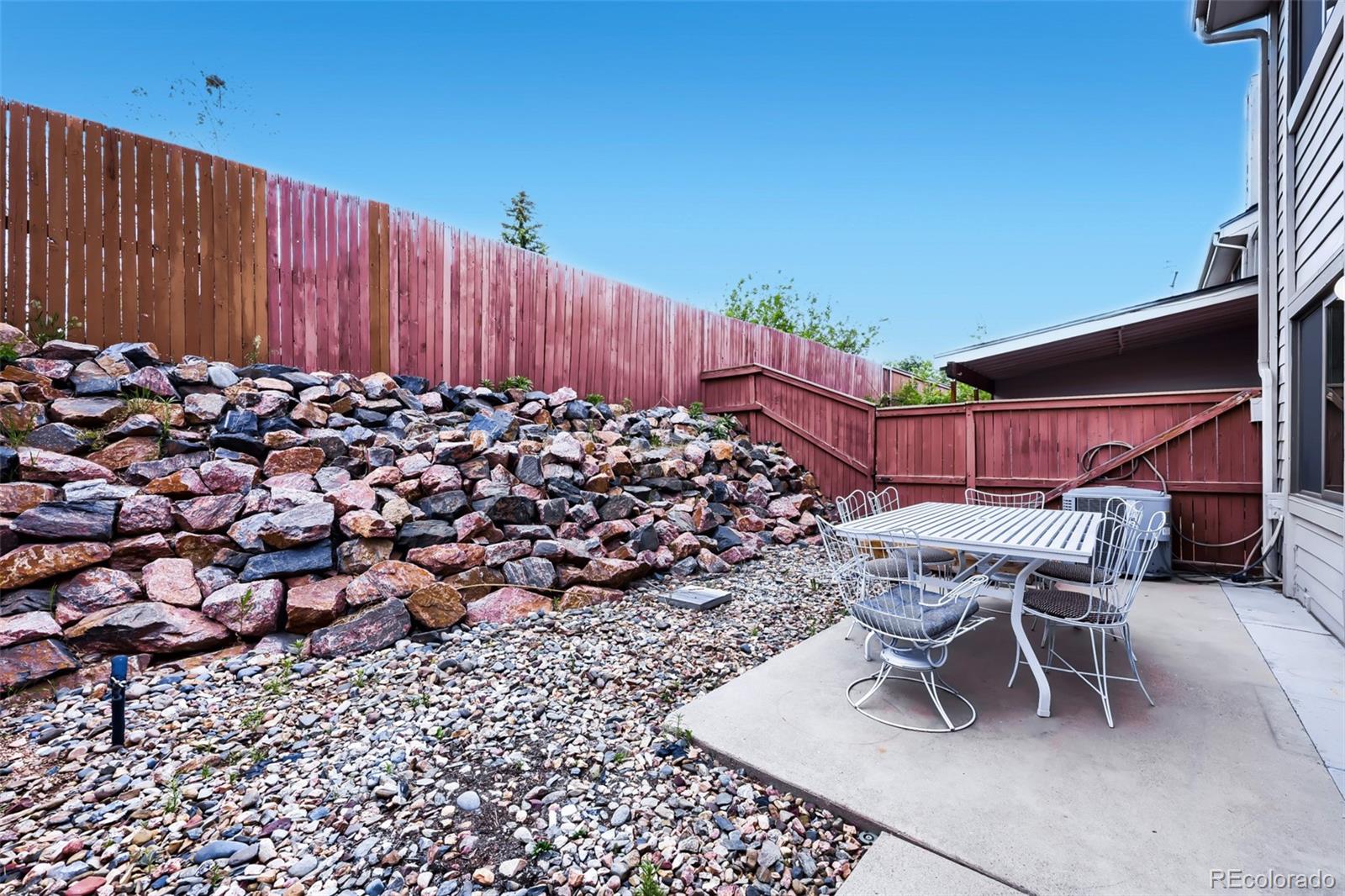 175 Xenon Street Denver, CO 80228 - Photo 26 of 37 a view of a chairs and table in backyard