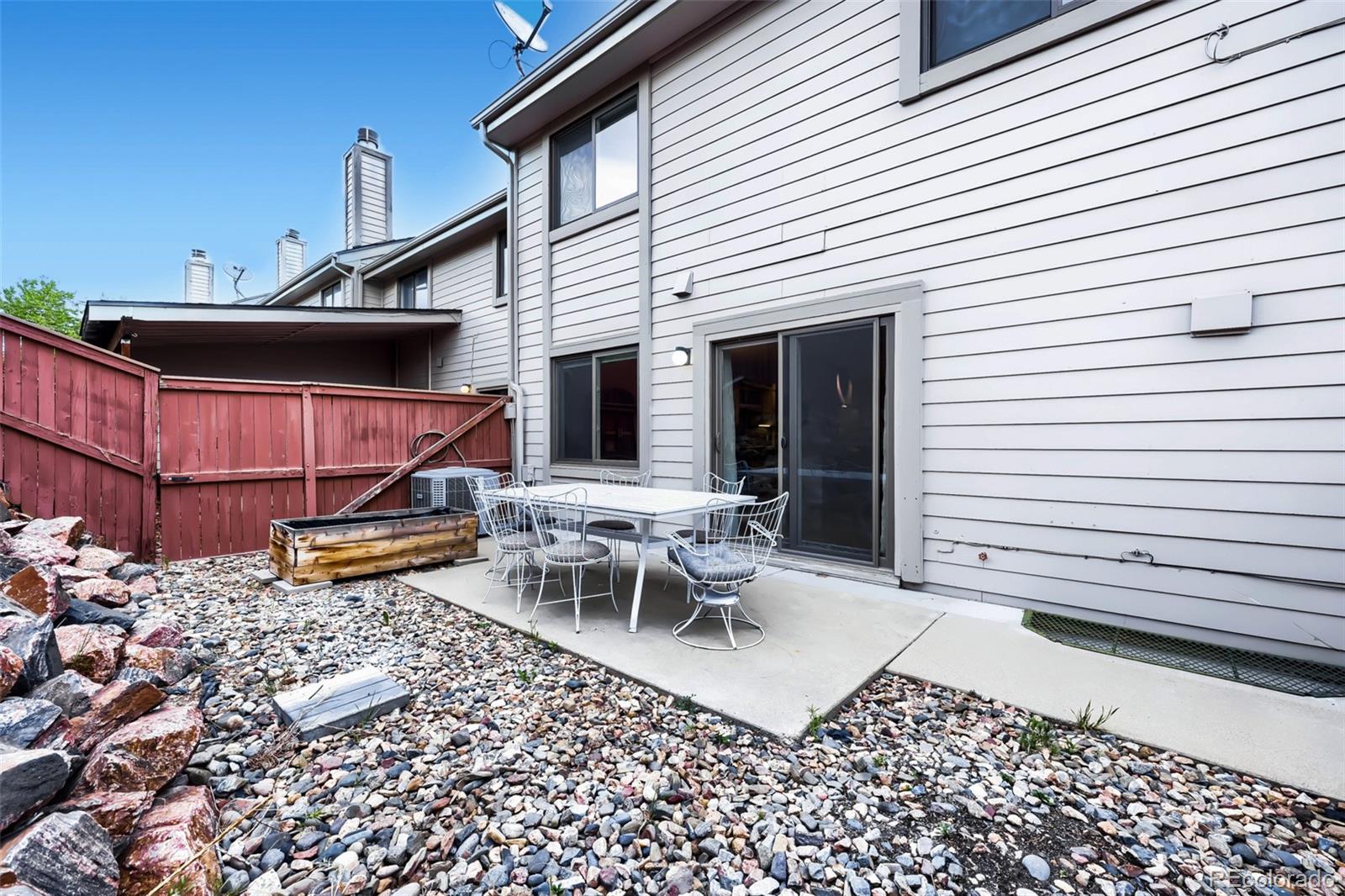 175 Xenon Street Denver, CO 80228 - Photo 27 of 37 a view of a patio with a table and chairs