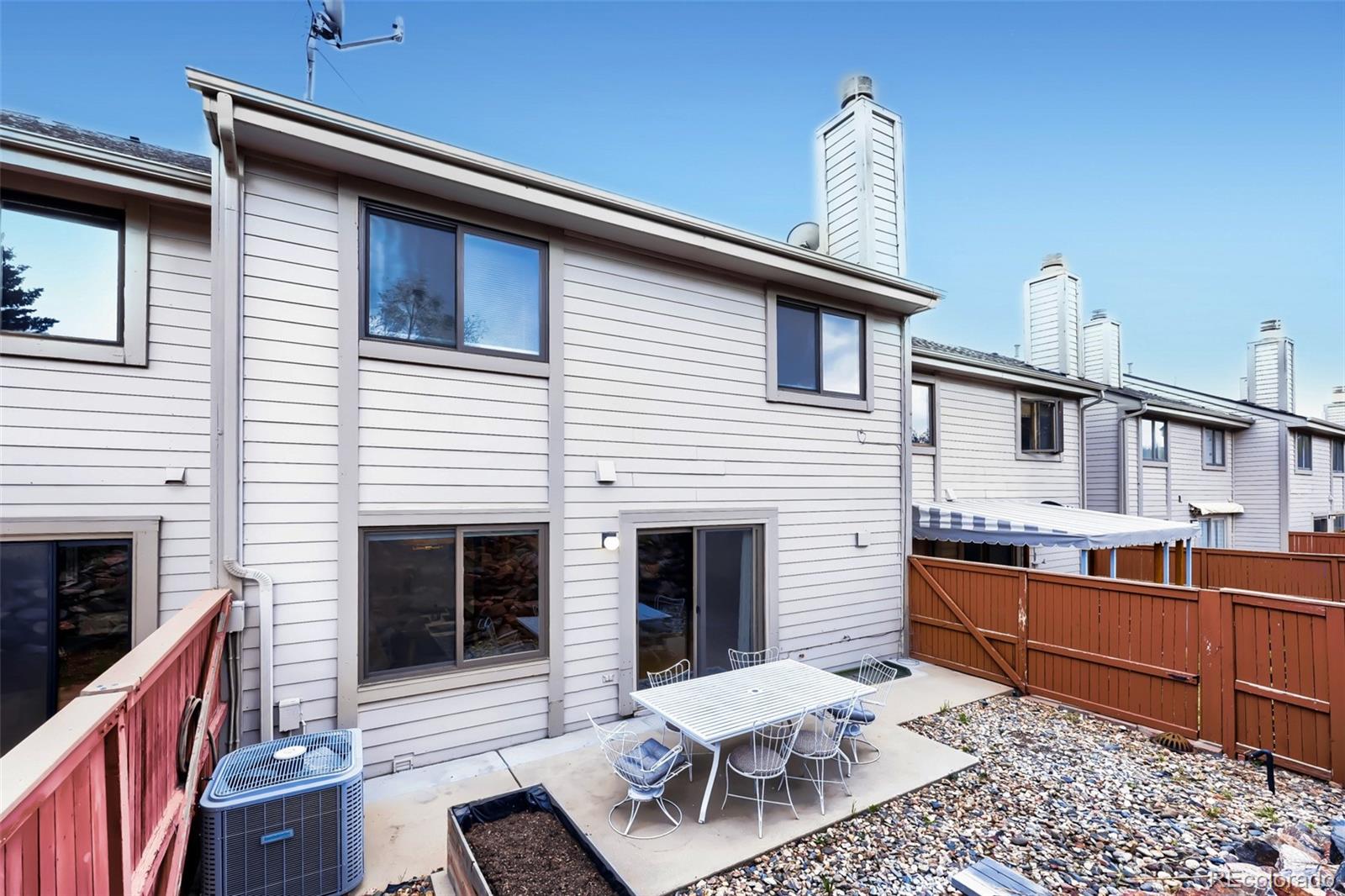 175 Xenon Street Denver, CO 80228 - Photo 28 of 37 a backyard of a house with outdoor seating