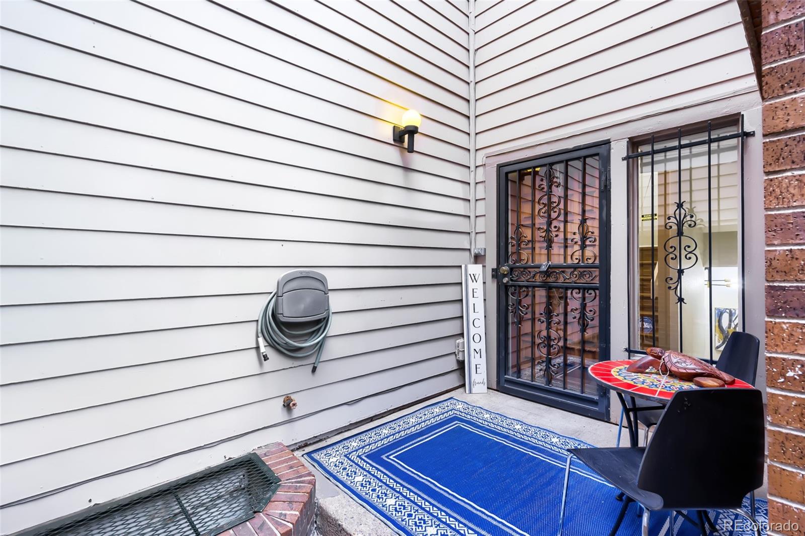 175 Xenon Street Denver, CO 80228 - Photo 3 of 37 a balcony view with a couple of chairs and potted plants on a wooden roof