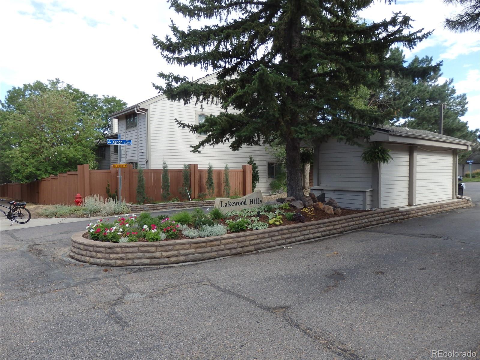 175 Xenon Street Denver, CO 80228 - Photo 33 of 37 a front view of a house with a garden