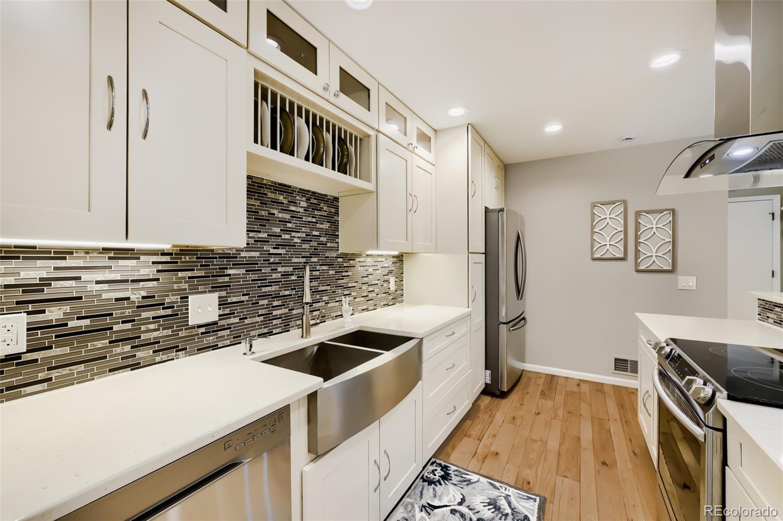 175 Xenon Street Denver, CO 80228 - Photo 8 of 37 a kitchen that has a sink and a stove