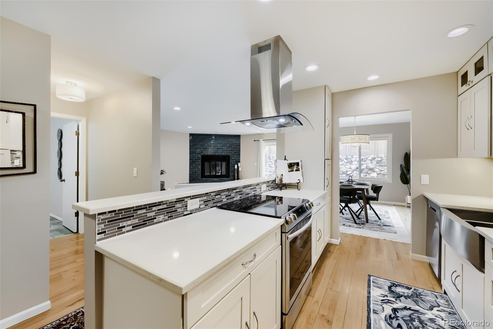 175 Xenon Street Denver, CO 80228 - Photo 9 of 37 a kitchen that has a sink a stove and chairs