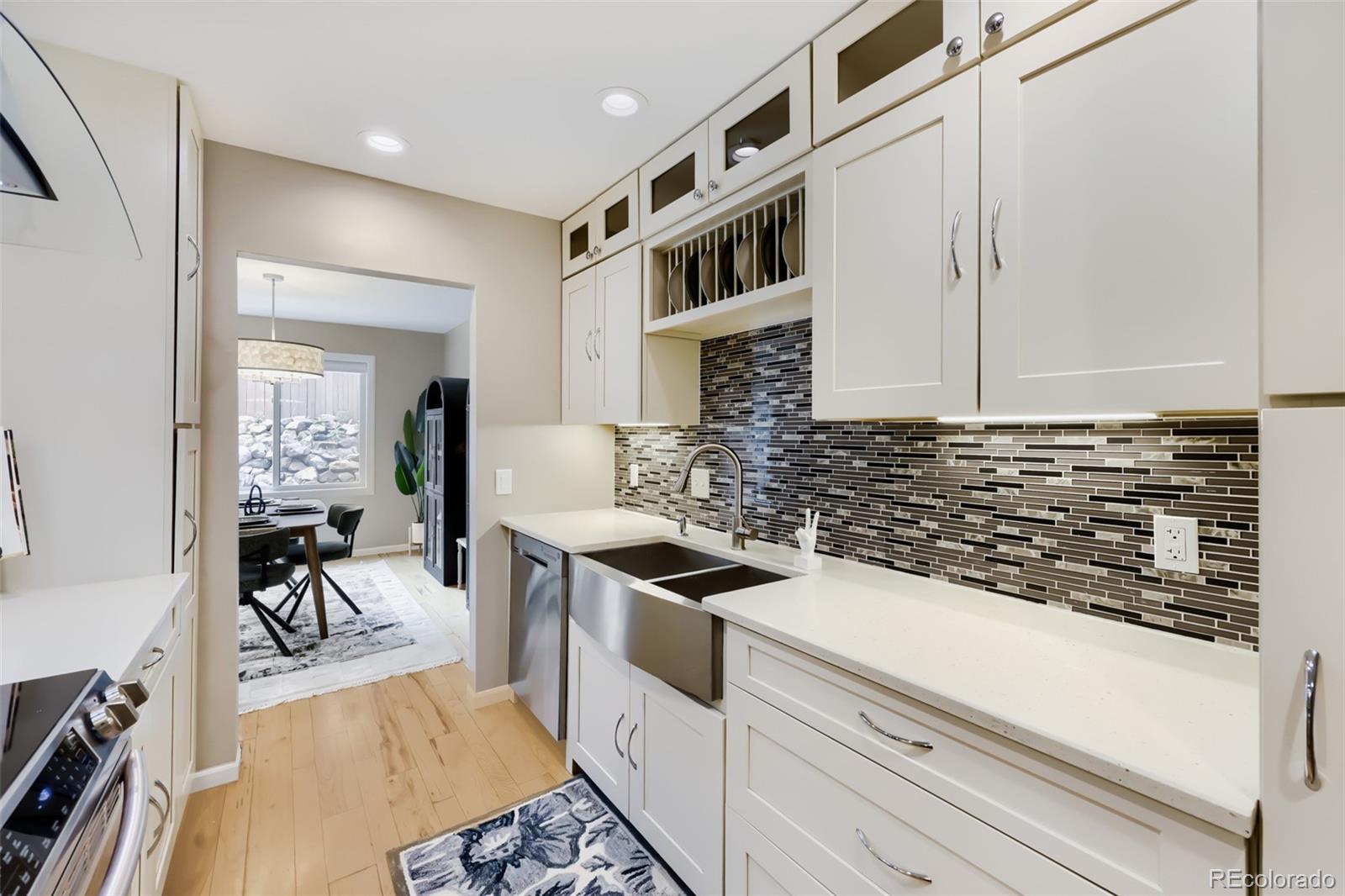 175 Xenon Street Denver, CO 80228 - Photo 10 of 37 a kitchen with stainless steel appliances granite countertop a stove and a refrigerator