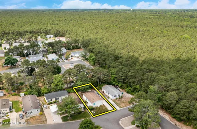 a view of a yard with two chairs