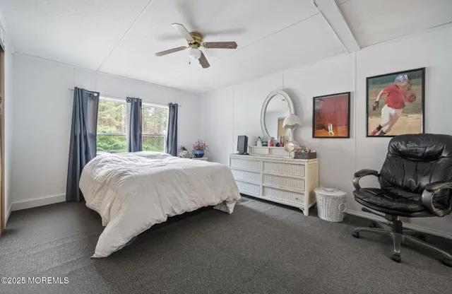 a spacious bedroom with a bed a couch and a window
