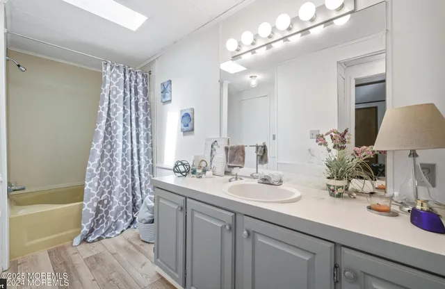 a bathroom with a double vanity sink and a mirror