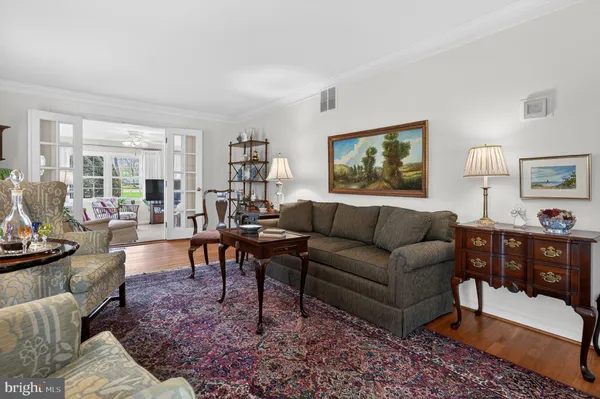 a living room with furniture a rug and a window