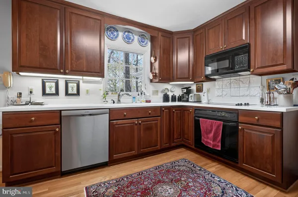 a kitchen with stainless steel appliances granite countertop a sink stove and microwave