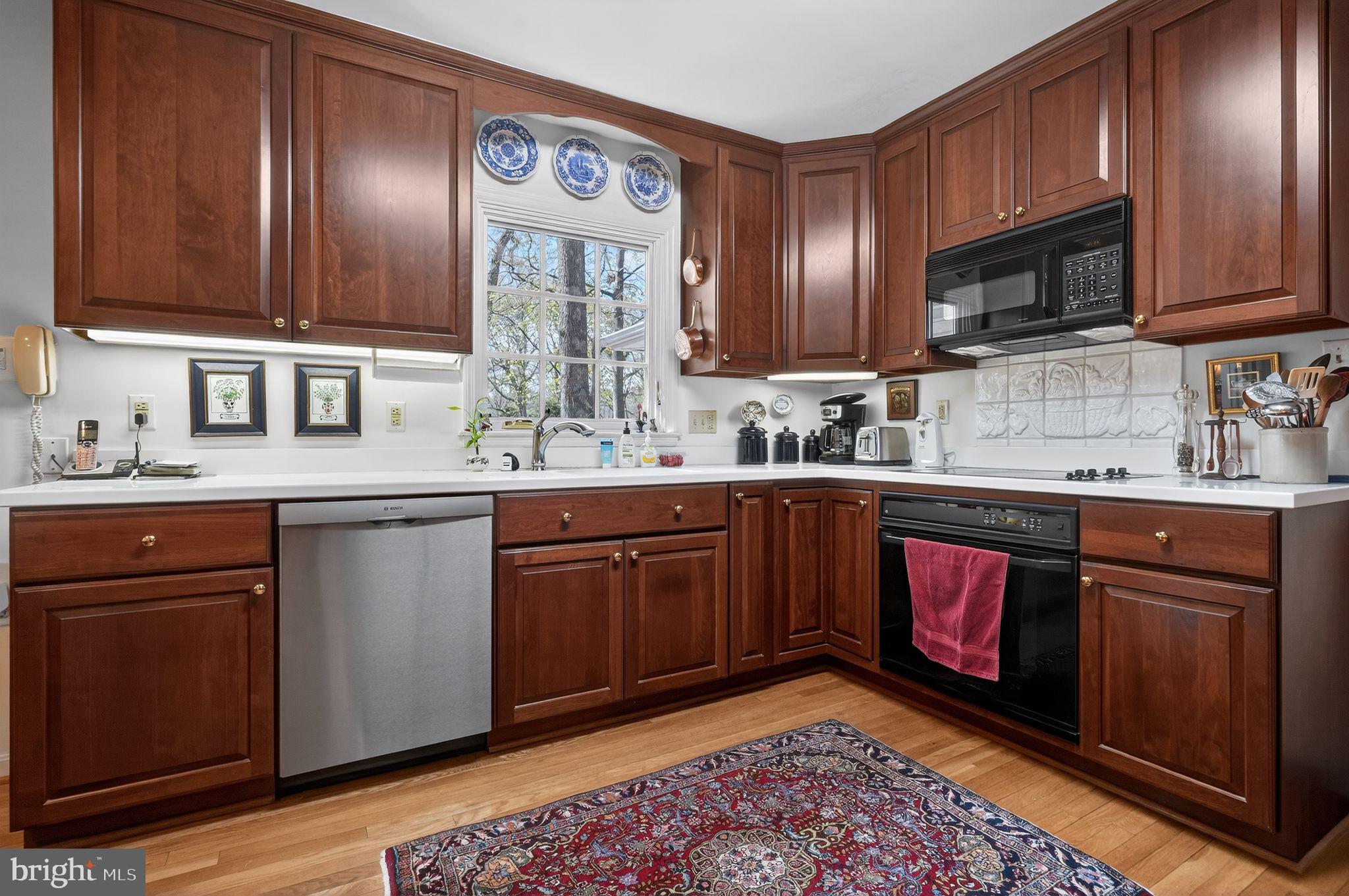 1510 Eton Way Crofton, MD 21114 - Photo 16 of 51 a kitchen with stainless steel appliances granite countertop a sink stove and microwave