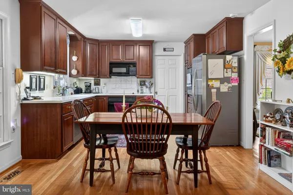 a dining table and chairs in a kitchen