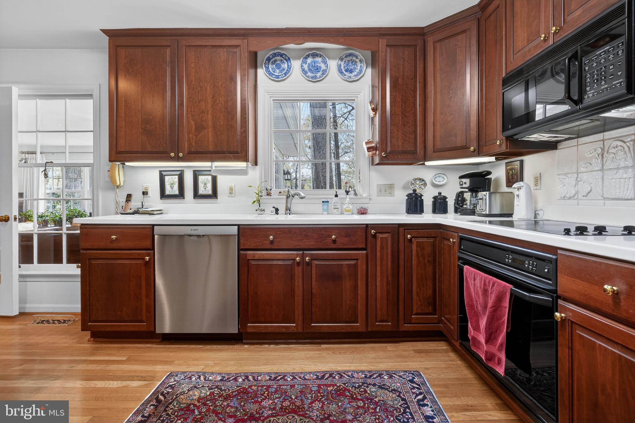1510 Eton Way Crofton, MD 21114 - Photo 19 of 51 a kitchen with stainless steel appliances granite countertop a sink stove and cabinets