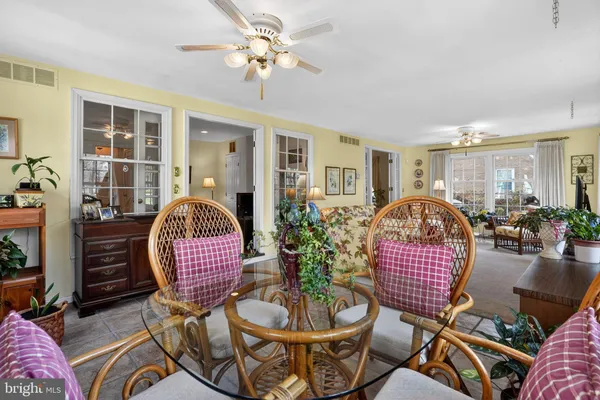 a living room with furniture a rug and a chandelier