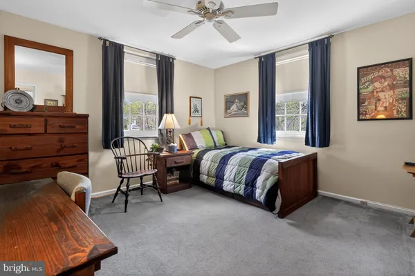 a spacious bedroom with a bed and large windows