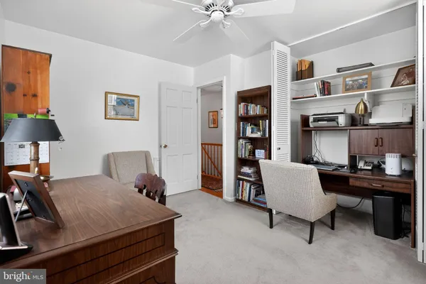 a bedroom with a bed and a desk