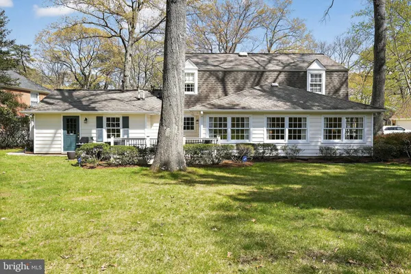 a front view of a house with a yard table and chairs