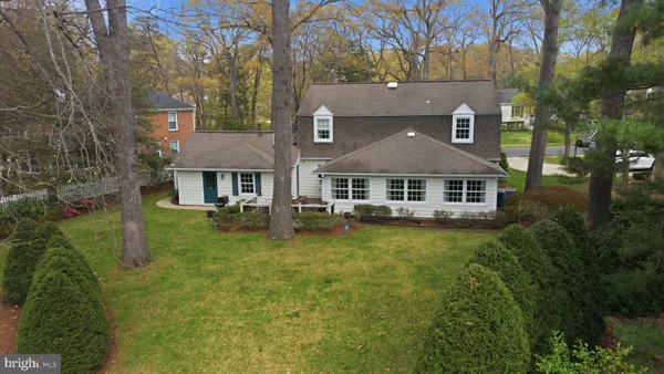 a aerial view of a house next to a big yard and large trees