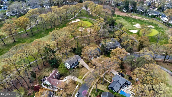 an aerial view of a house with a yard and lake view