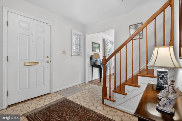a view of entryway with wooden floor and stairs
