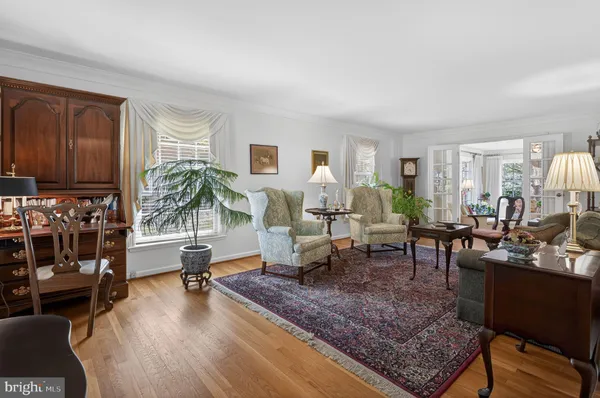 a living room with furniture a rug and a window