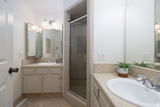 6936 South 775 East, Unit B Midvale, UT 84047 - Photo 15 of 33 Full bath with backsplash, two vanities, a shower stall, and light tile patterned floors