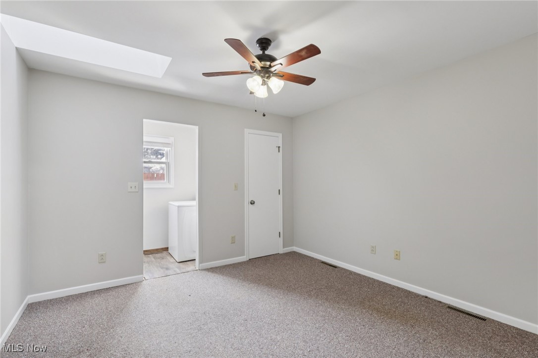 611 Wilson Street Struthers, OH 44471 - Photo 22 of 44 Unfurnished bedroom featuring a skylight, light colored carpet, and ceiling fan