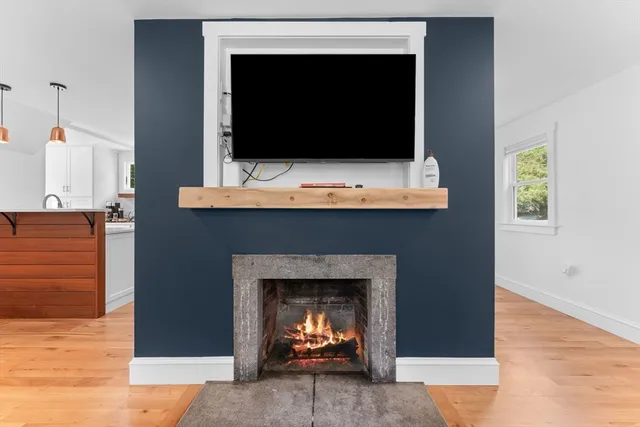 a living room with a fireplace and a flat screen tv