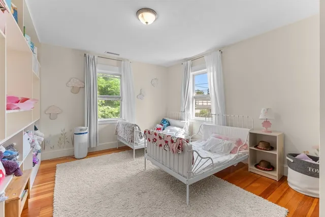 a bedroom with furniture and a large window