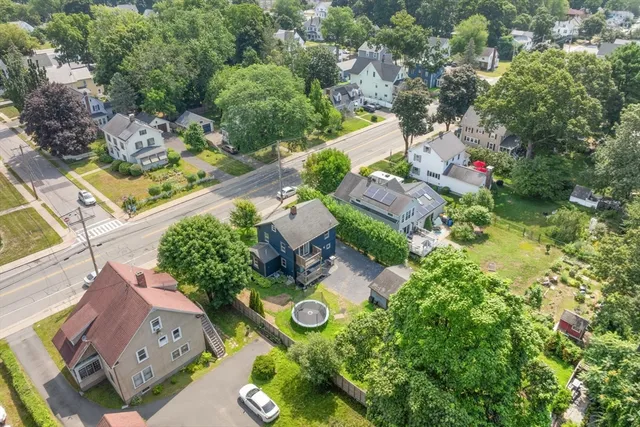 an aerial view of a house with garden space and street view