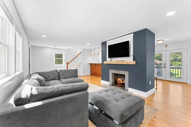 a living room with fireplace furniture and a flat screen tv