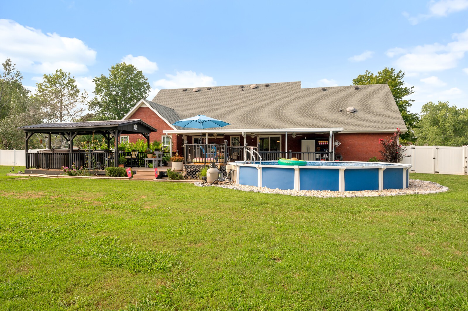 1123 Bramble Trail Murfreesboro, TN 37129 - Photo 53 of 60 a view of a large pool with lawn chairs under an umbrella