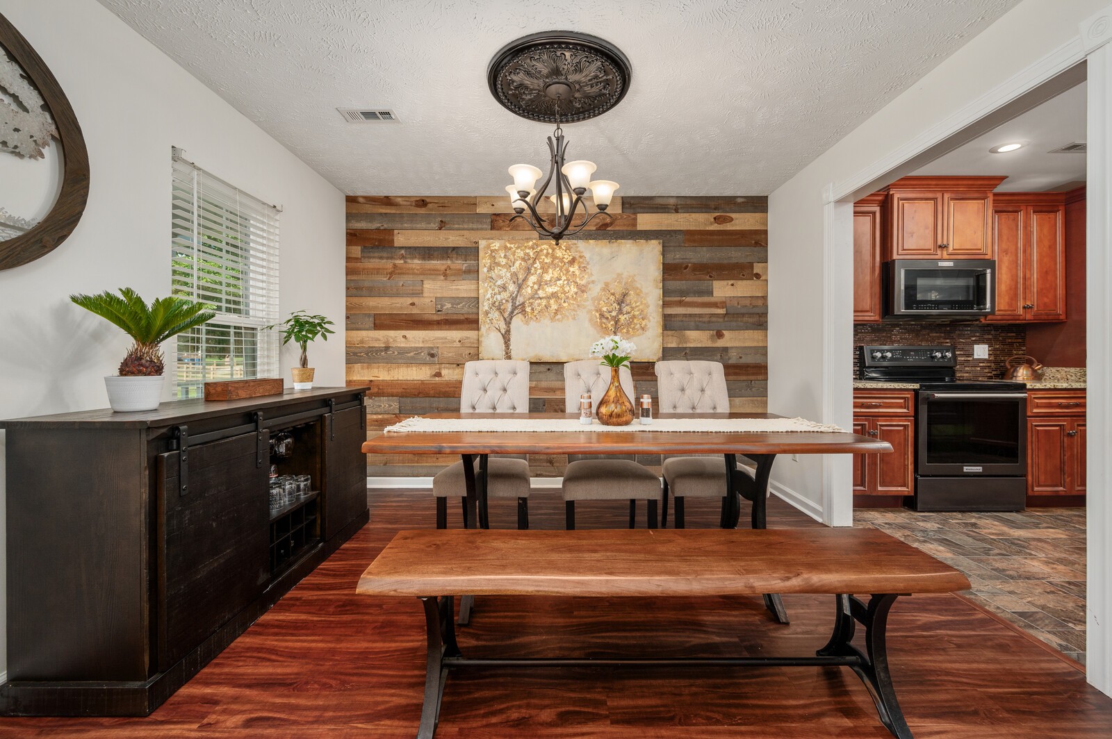 1123 Bramble Trail Murfreesboro, TN 37129 - Photo 8 of 60 a dining hall with granite countertop a stove a sink dishwasher and a dining table with wooden floor