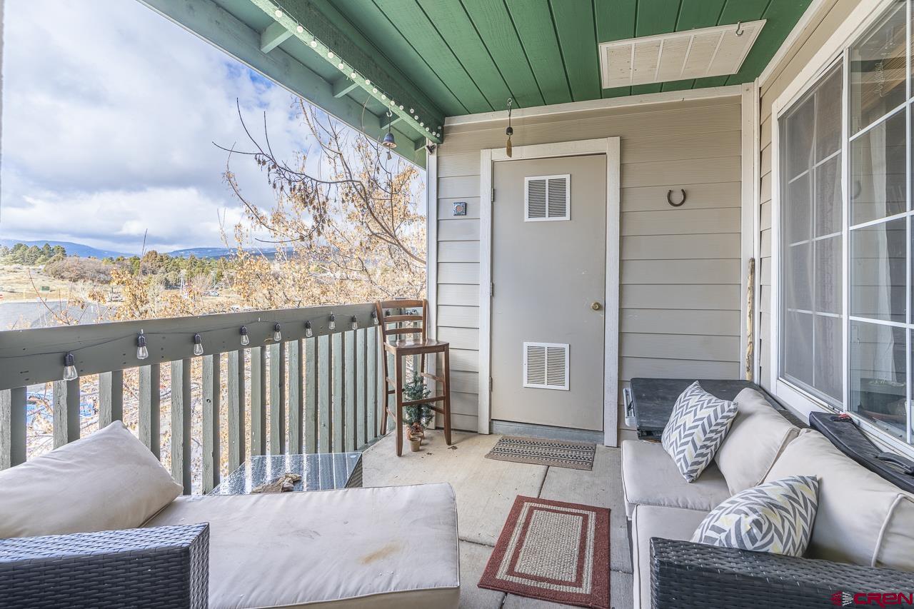 1100 Goeglein Gulch Road, Unit 222 Durango, CO 81301 - Photo 23 of 32 a balcony with furniture and a potted plant