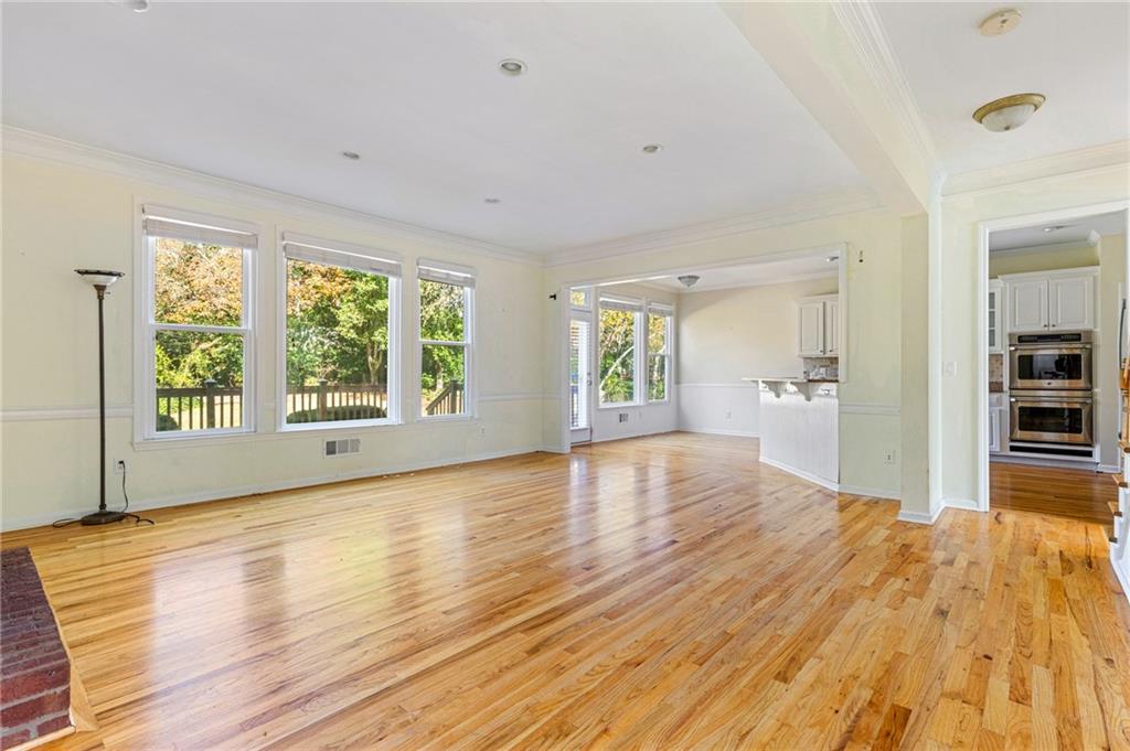 1355 Chattahoochee Run Drive Suwanee, GA 30024 - Photo 14 of 57 a view of a big room with wooden floor and windows