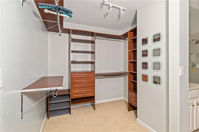a view of walk in closet with empty racks