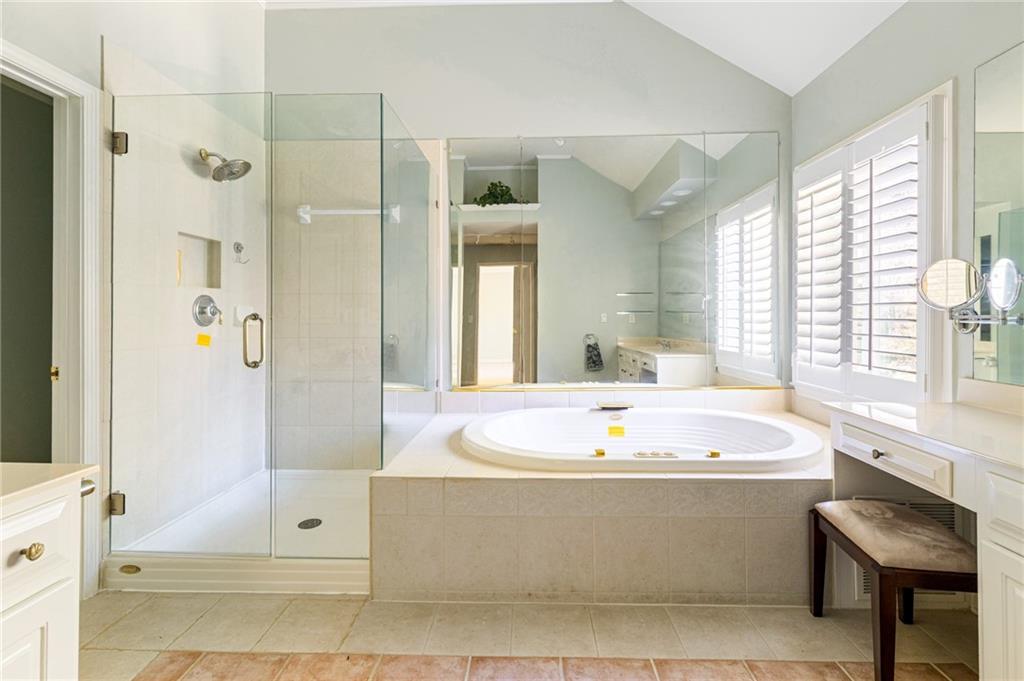 1355 Chattahoochee Run Drive Suwanee, GA 30024 - Photo 21 of 57 a bath tub sitting next to a bathroom sink