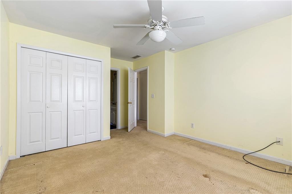 1355 Chattahoochee Run Drive Suwanee, GA 30024 - Photo 30 of 57 an empty room with a ceiling fan and a window