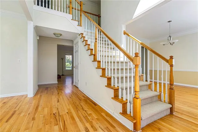 a view of entryway and hall with wooden floor