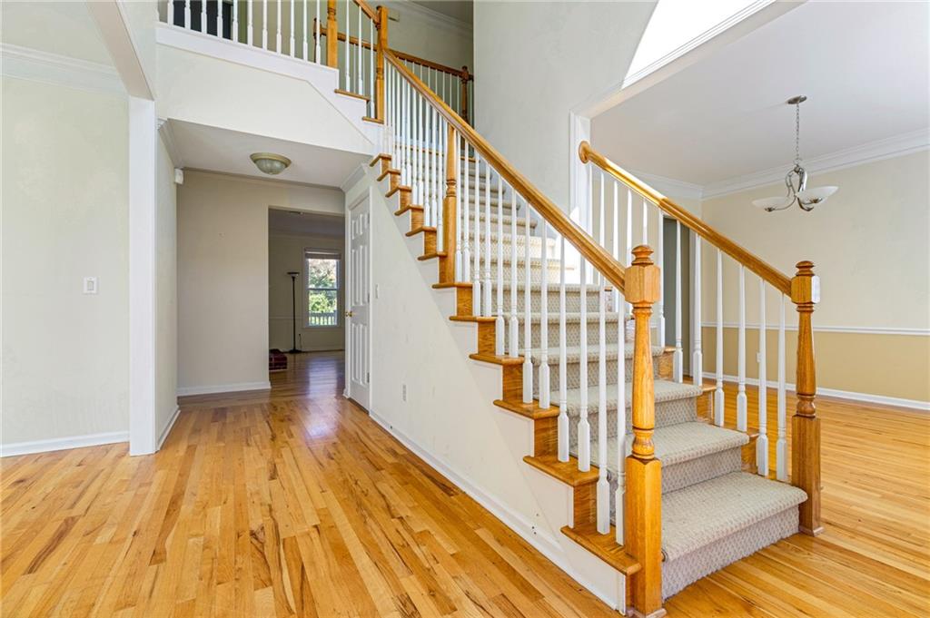 1355 Chattahoochee Run Drive Suwanee, GA 30024 - Photo 3 of 57 a view of entryway and hall with wooden floor