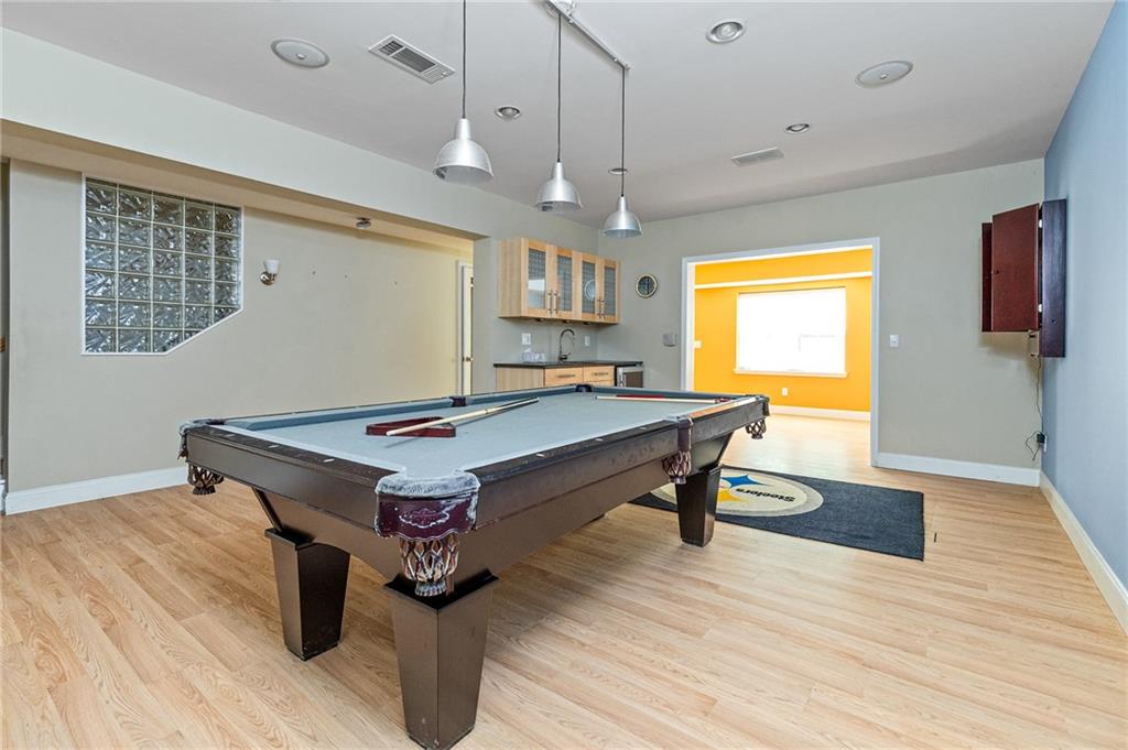 1355 Chattahoochee Run Drive Suwanee, GA 30024 - Photo 36 of 57 a living room with hard wood floors a table and a wooden floor