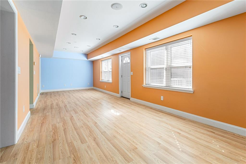 1355 Chattahoochee Run Drive Suwanee, GA 30024 - Photo 38 of 57 an empty room with wooden floor and windows