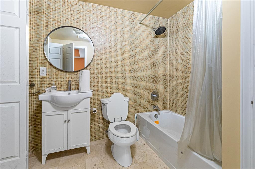 1355 Chattahoochee Run Drive Suwanee, GA 30024 - Photo 40 of 57 a bathroom with a toilet a sink and a mirror